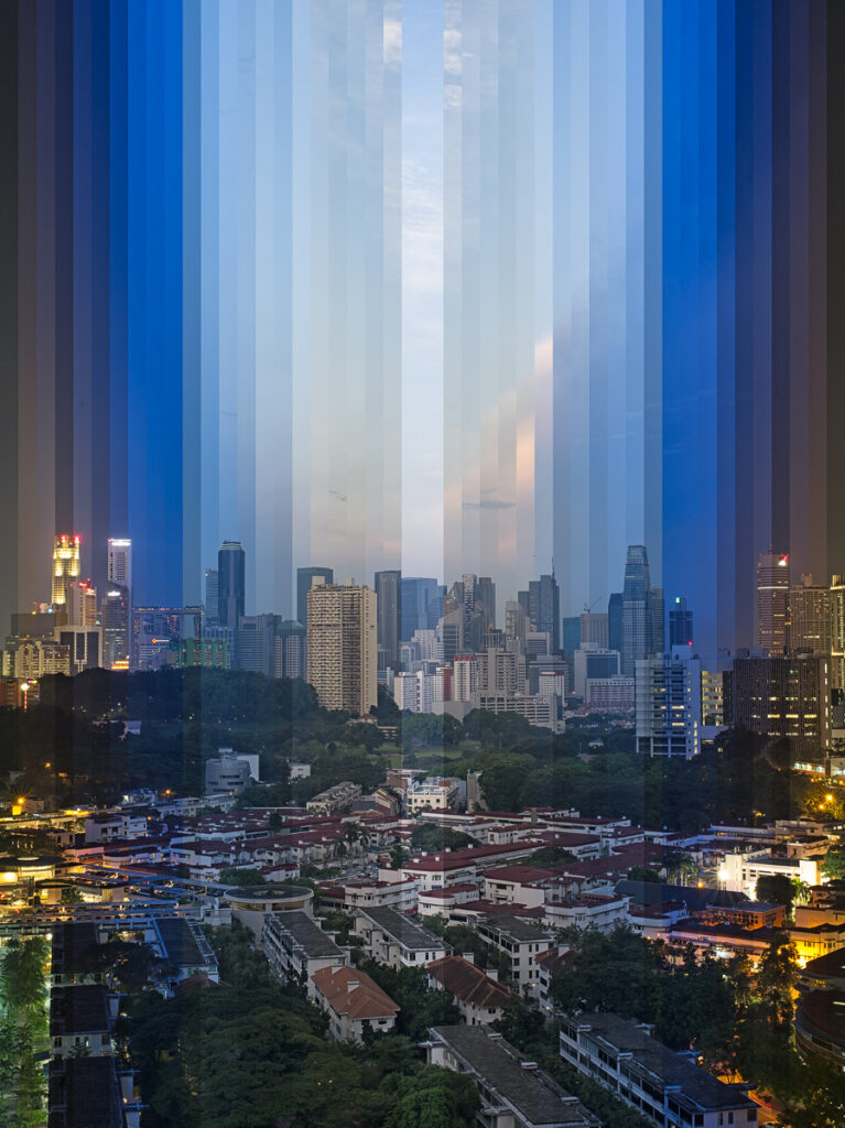 Tiong Bahru estate and the city skyline, the sky behind cut into vertical slices from day to dusk